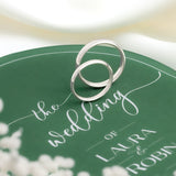 Two 9ct White gold wedding band in 2.5mm and 3.5mm displayed on a green wedding invite