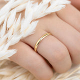 A woman hand with a 9ct gold wedding band with 1.3 mm cubic zirconia stone