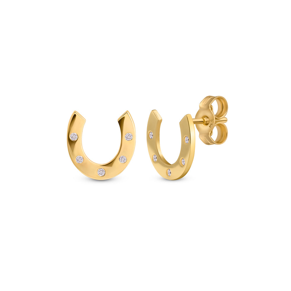 Gold Horseshoe Studs with cubic zirconia stones placed on a white background 