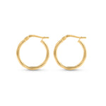 Gold hoop earrings with a twisted pattern placed against a white background