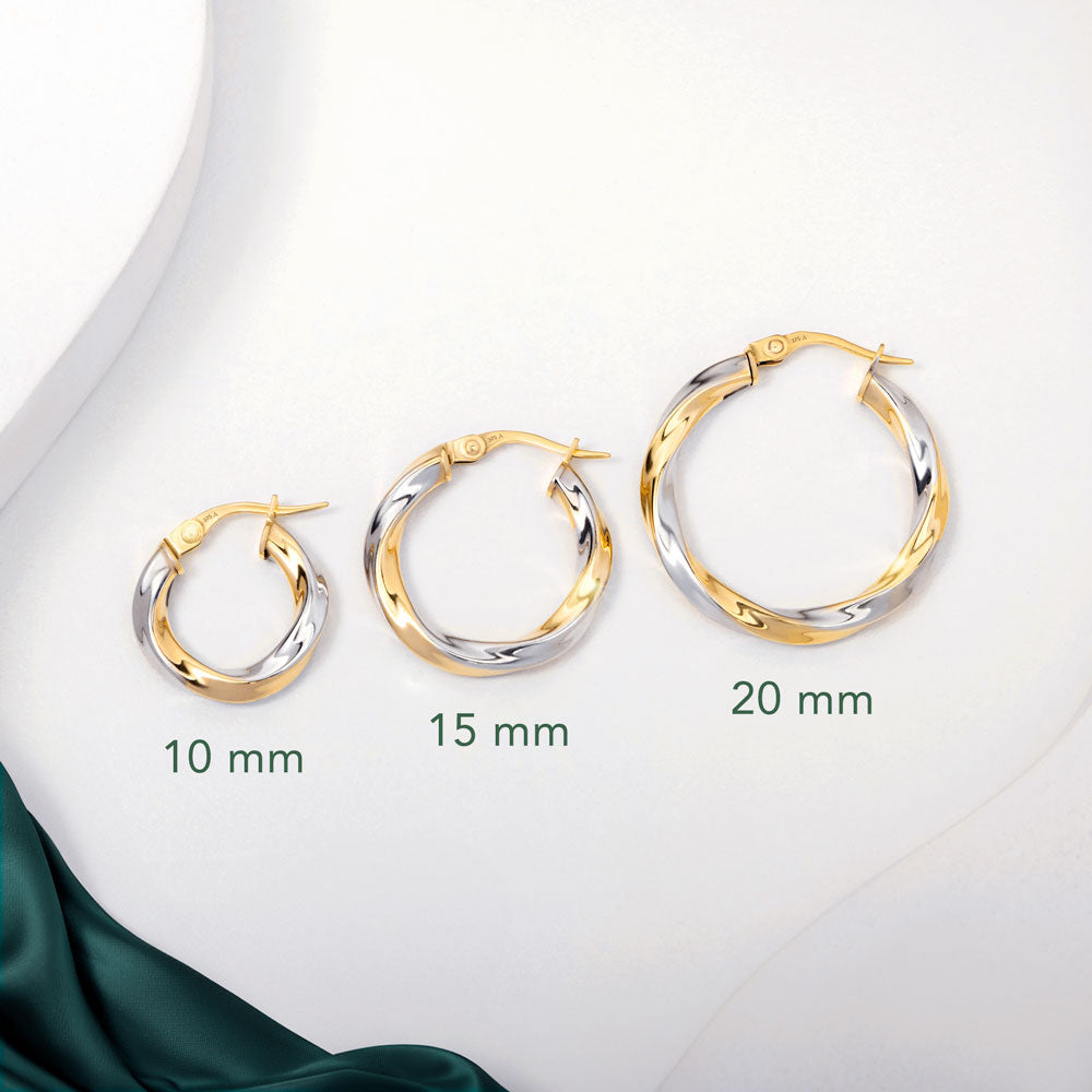 Three pairs of 2 tone gold twisted hoops earrings placed on a white surface