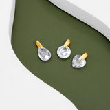 An image showing three 9ct gold crystal pendants Waterdrop shape Round shape and Heart shape placed on a green and white background.