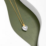 An image showing one 9ct gold Heart crystal pendant placed on a green and white background.