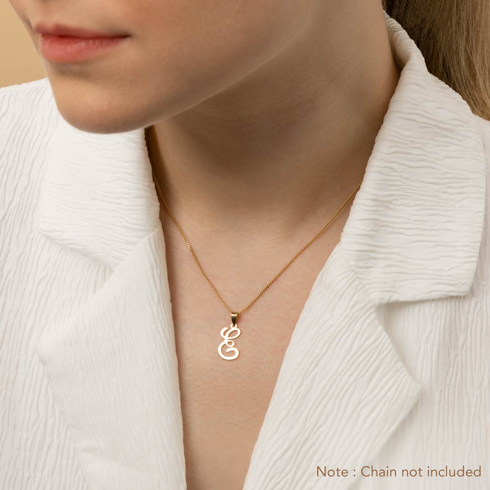 A woman wearing a gold necklace with an alphabet pendant in the shape of the letter 'E'. The text in the corner notes, "Note: Chain not included.