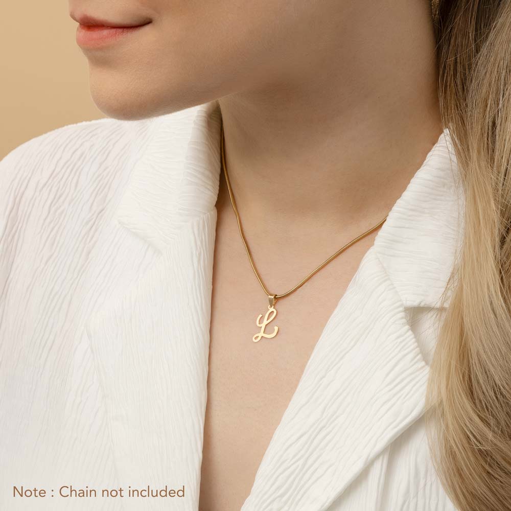 A woman wearing a gold necklace with an alphabet pendant in the shape of the letter 'L'. The text in the corner notes, "Note: Chain not included.