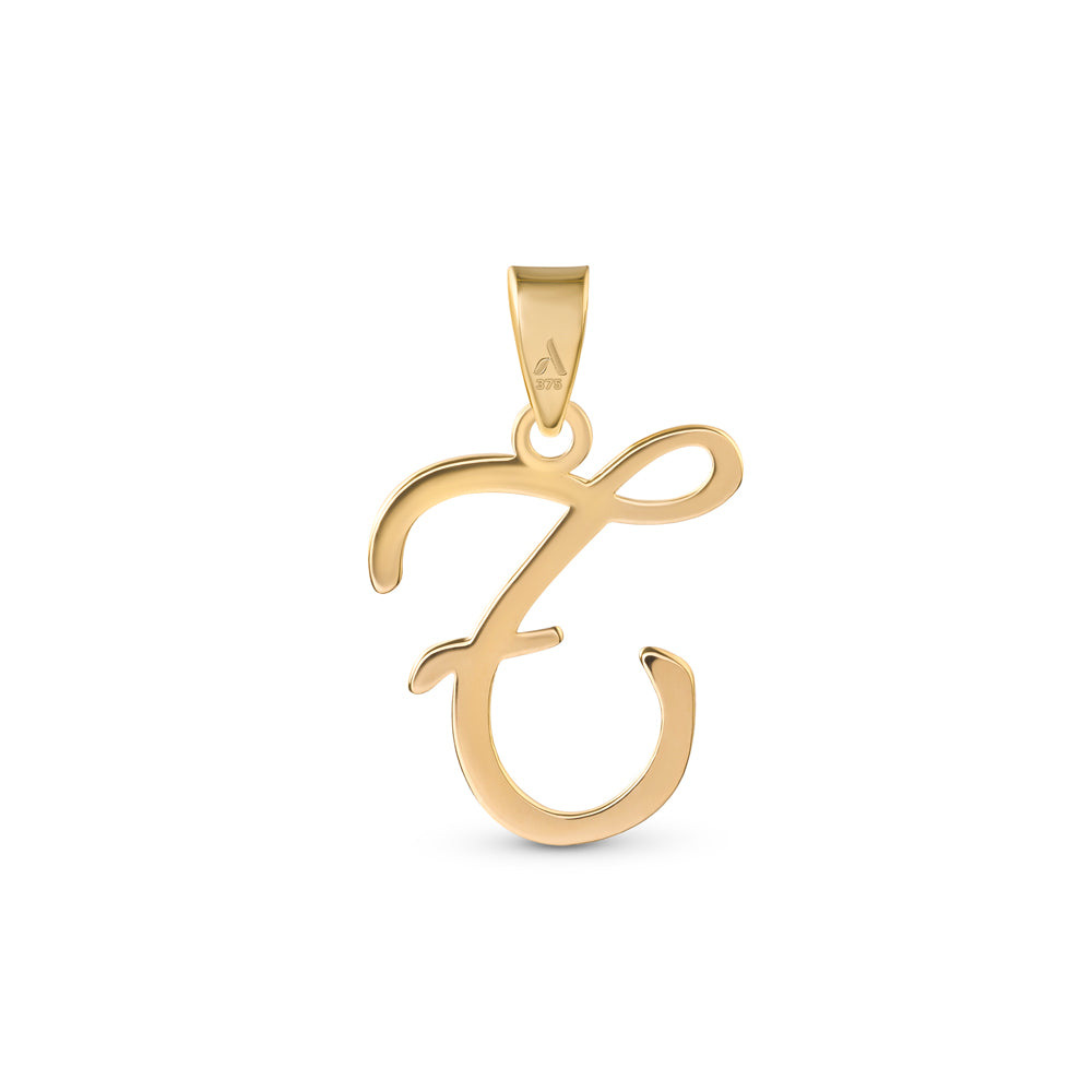 A gold pendant shaped like the letter "T" designed with elegant curves and a flowing script style with a small loop at the top for attaching to a chain.