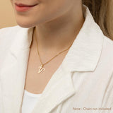 A woman wearing a gold necklace with an alphabet pendant in the shape of the letter 'V'. The text in the corner notes, "Note: Chain not included.