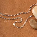 Two paperclip bracelets of different thickness placed on a brown background next to beige pebbles