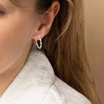 Model wearing Silver Textured Hoops with post notch.