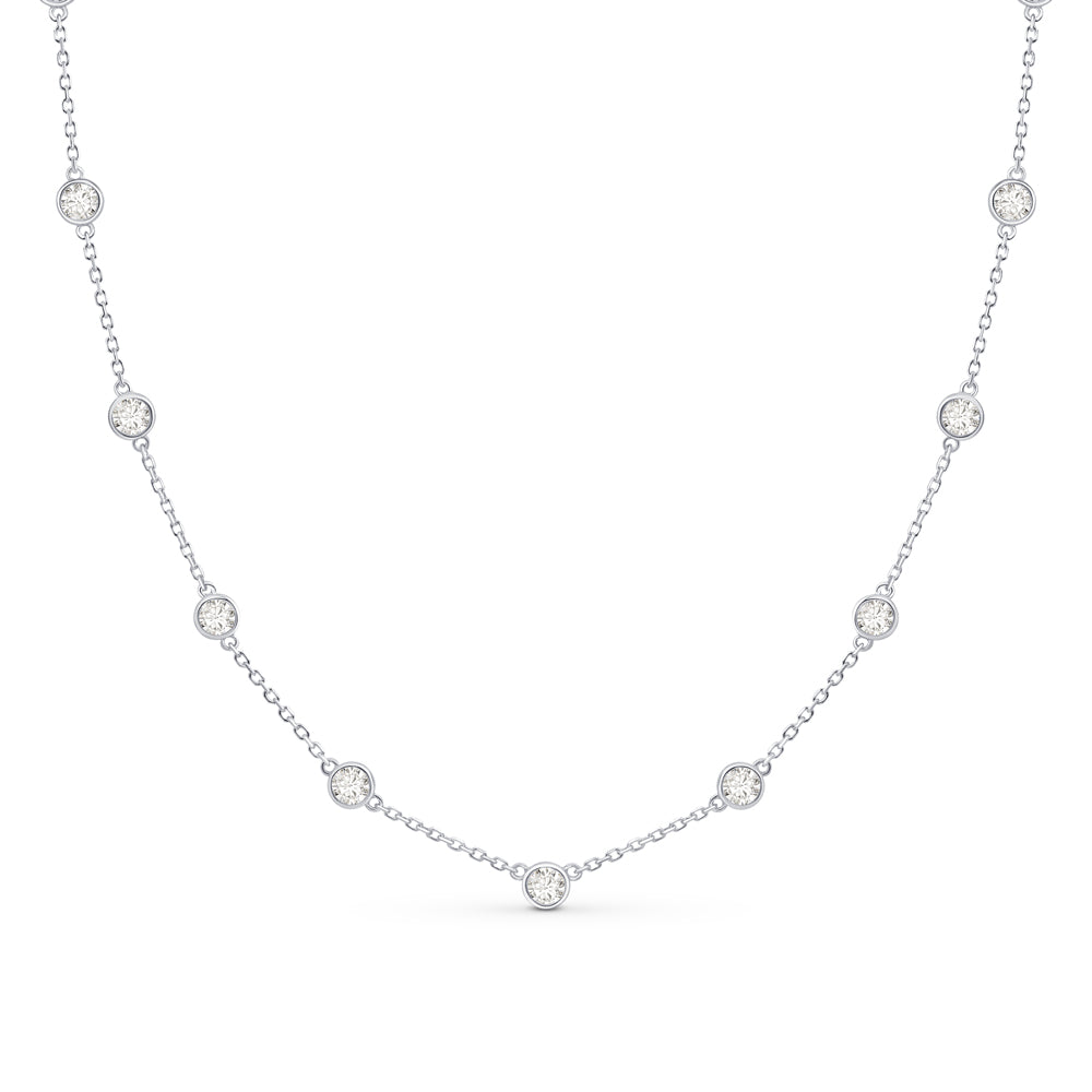 Silver CZ charm necklace placed against a white background