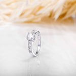 An image showing one silver engagement ring with CZ stone in 6mm placed on a white and beige background.