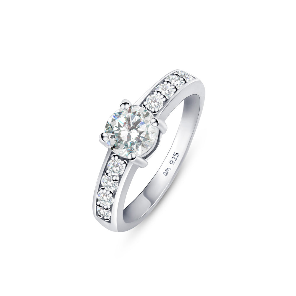 Silver engagement ring with CZ stone in 6mm placed on a white surface.