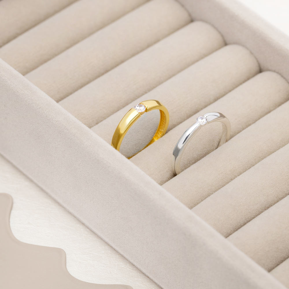 An image showing two solitaire wedding band with CZ stone in 3mm in silver and gold plated.