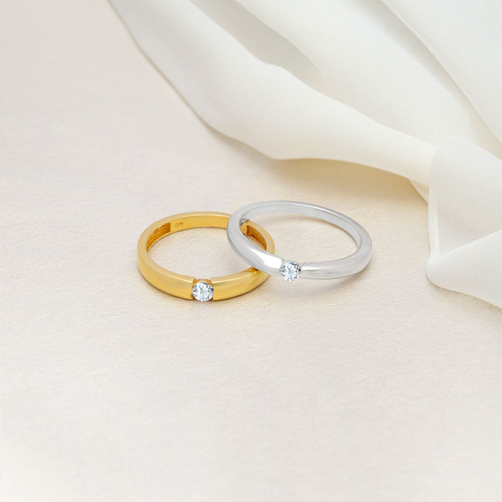 An image showing two solitaire wedding band with CZ stone in 3mm in silver and gold plated.