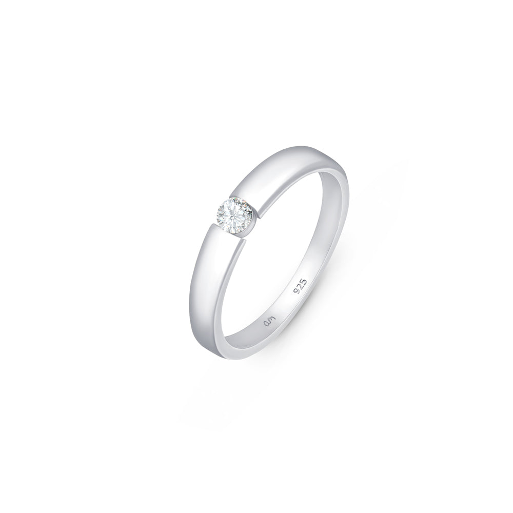 Silver solitaire wedding band with CZ stone in 3mm placed on a white surface.