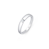 Silver solitaire wedding band with CZ stone in 3mm placed on a white surface.