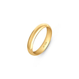 Gold plated wedding band in 4mm thick placed on a white surface.