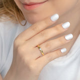 Woman wearing gold plated solitaire wedding band with CZ stone in 3mm.