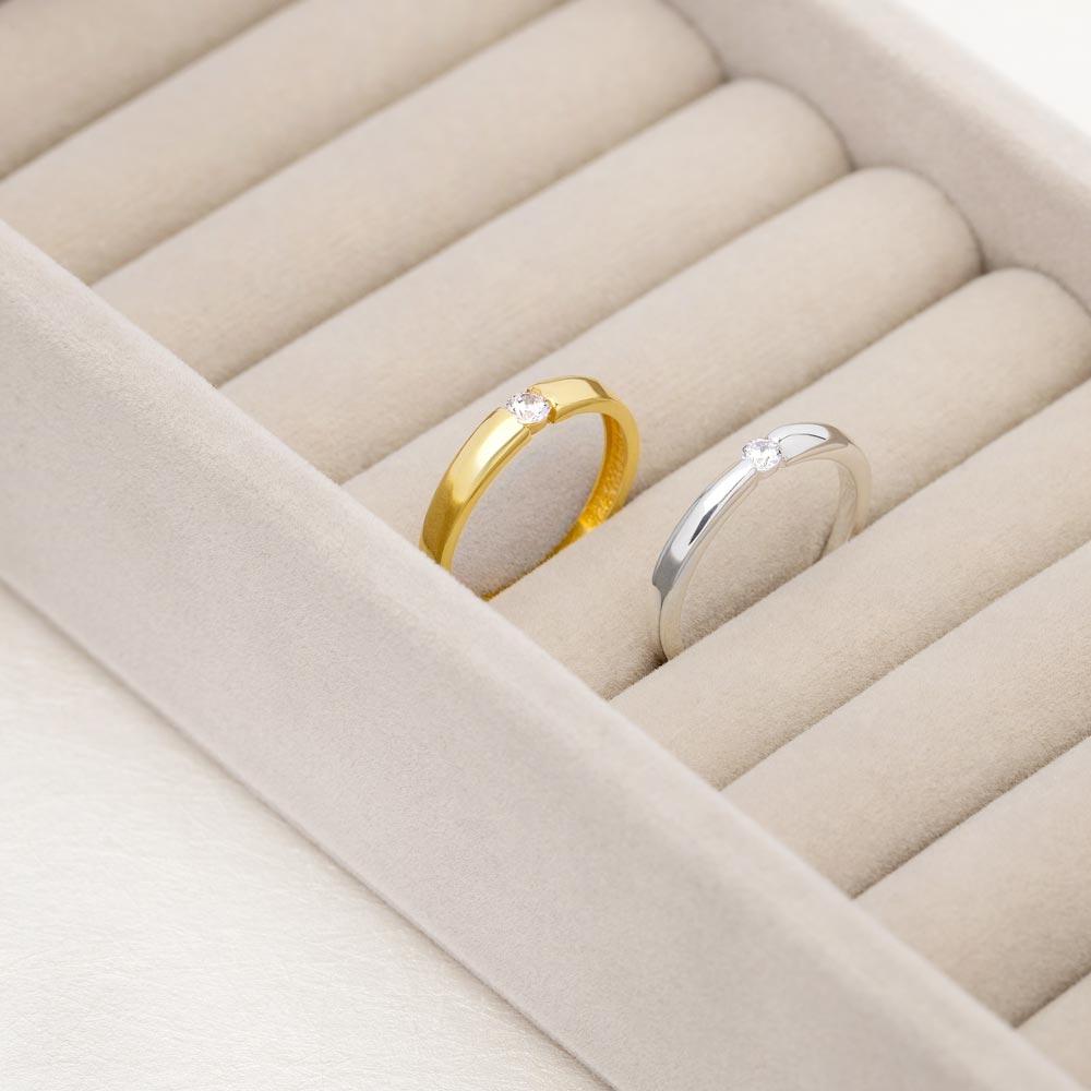 An image showing two solitaire wedding band with CZ stone in 3mm in silver and gold plated.