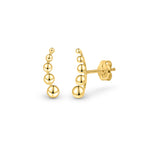 Two Shining gold balls crawler earrings against a white background