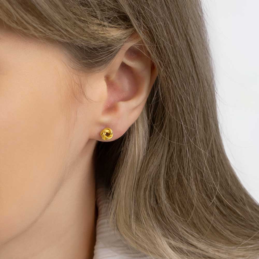 Picture of a Textured knot studs earring on a young woman