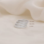 Three silver rings of different thickness 2.5mm 3.5mm 4mm placed over other to show its size difference