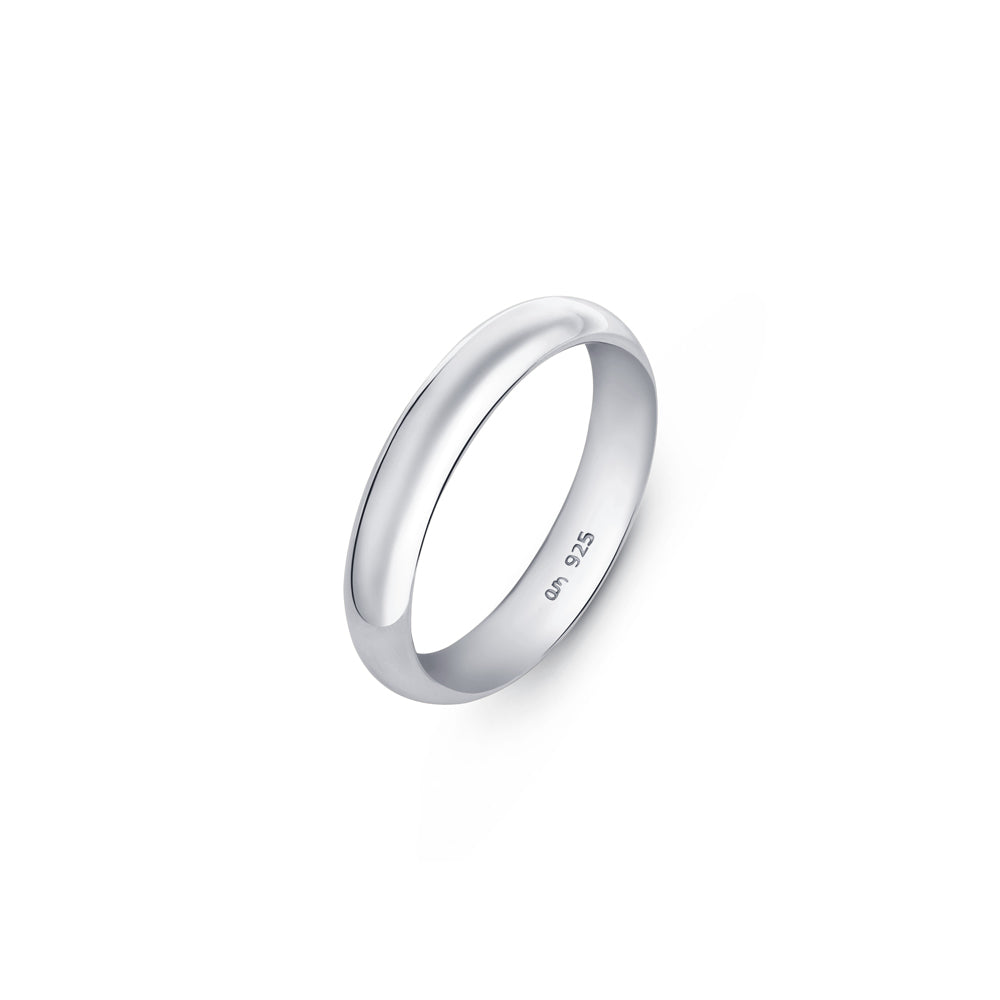 Thick wedding ring 4mm in width made of 925 silver placed on a clean white backdrop